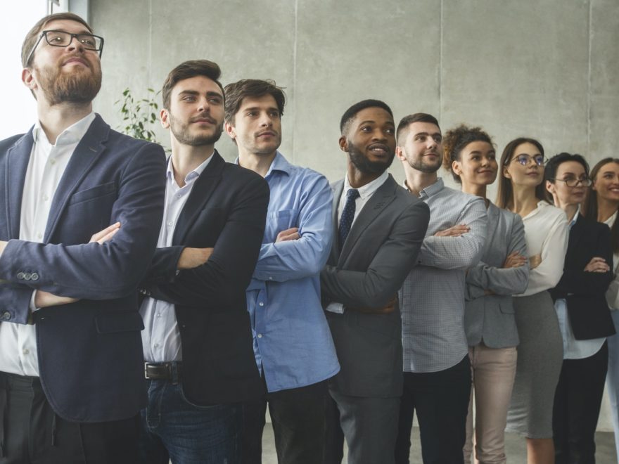 Successful business team standing in row headed with boss